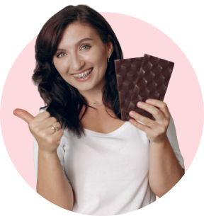 lady smiles at the camera with chocolate